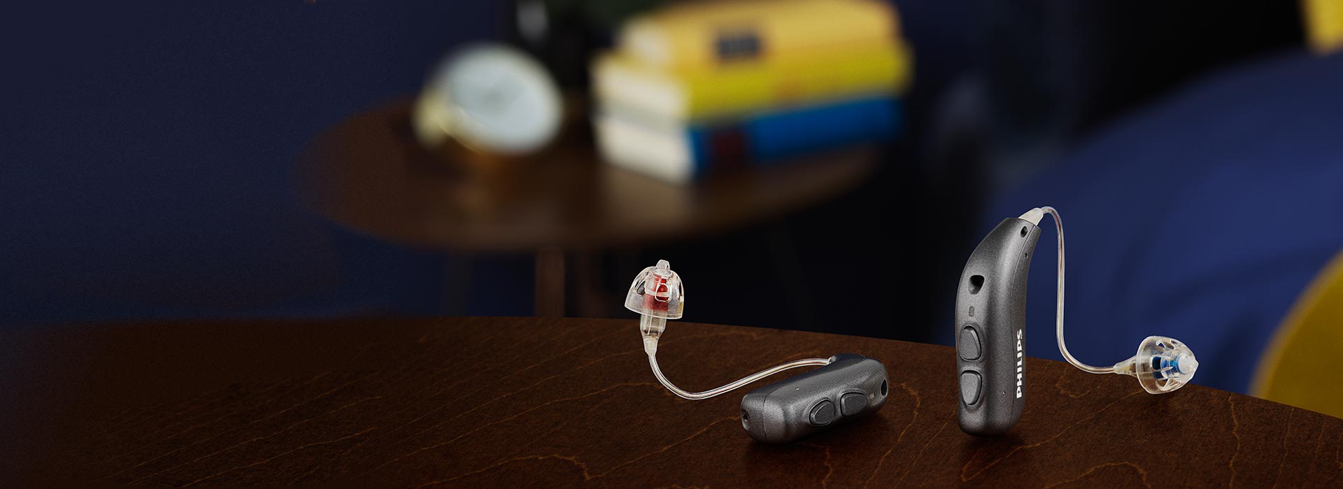 Philips HearLink hearing aids placed on a table in a bedroom