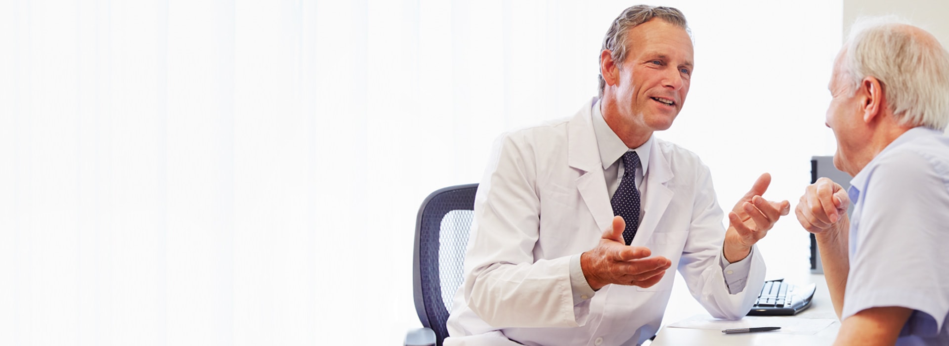 A man at a consultation at a hearing care specialist or an audiologist